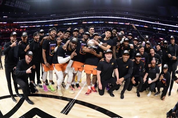 The Phoenix Suns pose with the Western Conference Finals trophy after Game 6 of the Western Conference Finals of the 2021 NBA Playoffs on June 30,...
