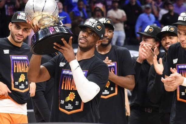 Chris Paul of the Phoenix Suns holds the Western Conference Finals trophy after Game 6 of the Western Conference Finals of the 2021 NBA Playoffs on...