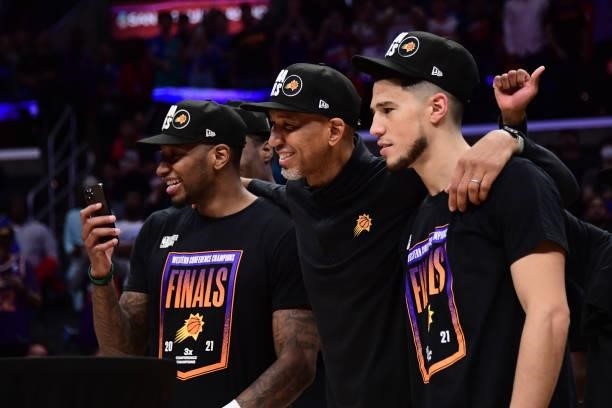 Torrey Craig and Devin Booker pose for a photo with Head Coach Monty Williams of the Phoenix Suns during Game 6 of the Western Conference Finals of...