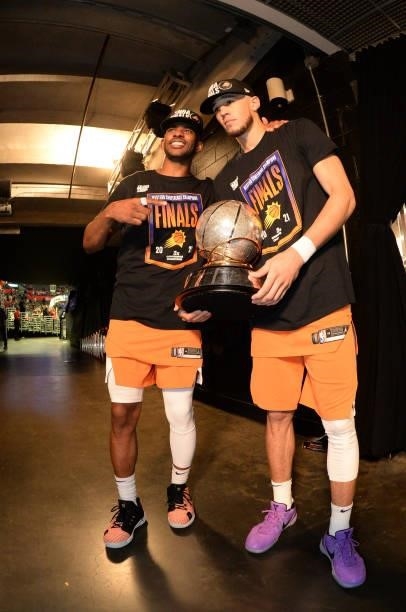 Chris Paul of the Phoenix Suns and Devin Booker of the Phoenix Suns pose with the Western Conference Finals trophy after Game 6 of the Western...
