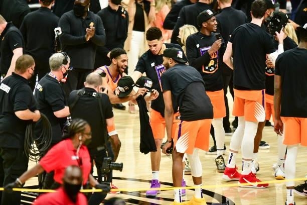 Cameron Payne of the Phoenix Suns, Devin Booker of the Phoenix Suns, and Mikal Bridges of the Phoenix Suns celebrate after the game against the LA...