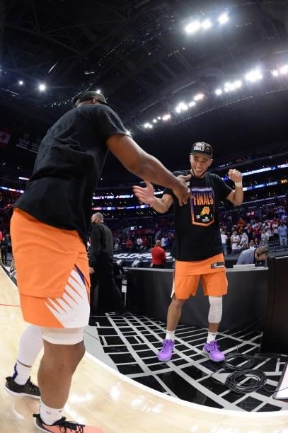 Chris Paul of the Phoenix Suns high fives Devin Booker of the Phoenix Suns after winning the Western Conference Finals of the 2021 NBA Playoffs on...