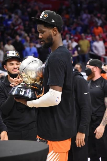 Deandre Ayton of the Phoenix Suns holds the Western Conference Finals trophy after winning Game 6 of the Western Conference Finals of the 2021 NBA...