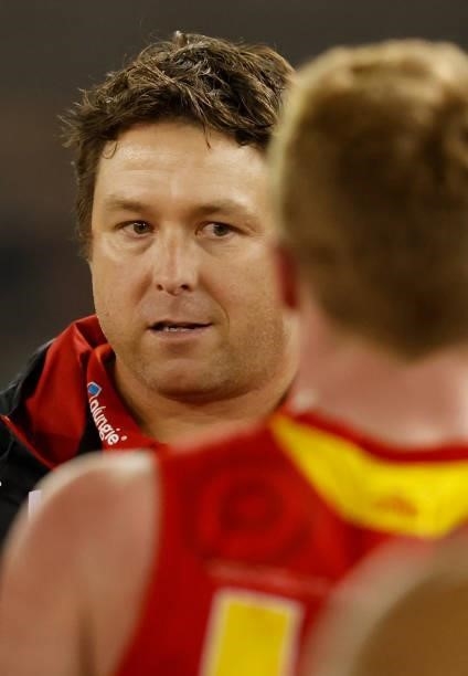 Stuart Dew, Senior Coach of the Suns addresses his players during the 2021 AFL Round 16 match between the Gold Coast Suns and the Richmond Tigers at...