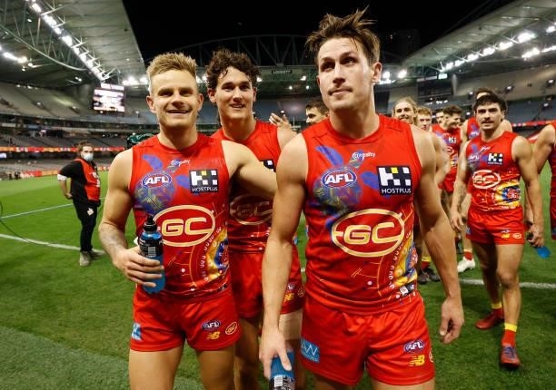 Brandon Ellis , Wil Powell and David Swallow of the Suns celebrate during the 2021 AFL Round 16 match between the Gold Coast Suns and the Richmond...