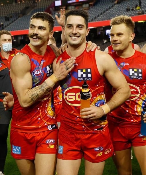 Oleg Markov, Brayden Fiorini and Brandon Ellis of the Suns celebrate during the 2021 AFL Round 16 match between the Gold Coast Suns and the Richmond...