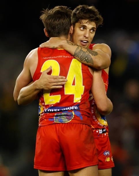 David Swallow and Sean Lemmens of the Suns celebrate during the 2021 AFL Round 16 match between the Gold Coast Suns and the Richmond Tigers at Marvel...