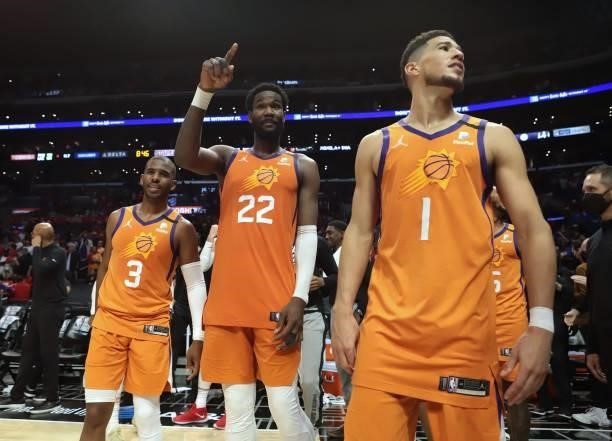 Chris Paul, Deandre Ayton and Devin Booker of the Phoenix Suns look on during Game 6 of the Western Conference Finals of the 2021 NBA Playoffs on...