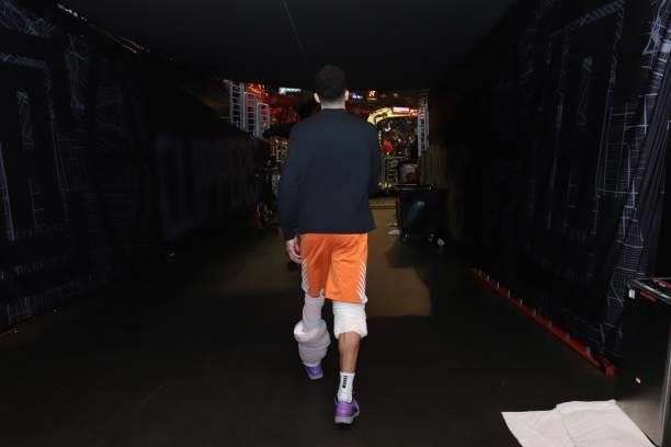Devin Booker of the Phoenix Suns walks onto the arena before the game against the LA Clippers during Game 6 of the Western Conference Finals of the...