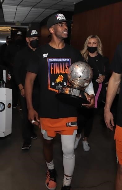Chris Paul of the Phoenix Suns leaves the arena holding the Western Conference Finals Trophy after winning the Western Conference Finals of the 2021...