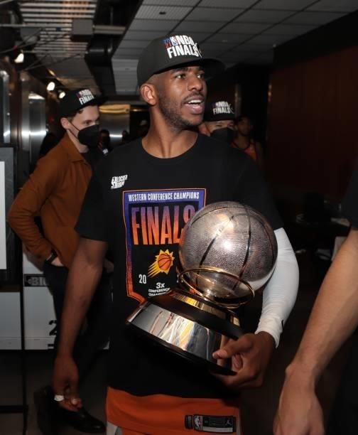 Chris Paul of the Phoenix Suns leaves the arena holding the Western Conference Finals Trophy after winning the Western Conference Finals of the 2021...