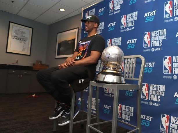 Chris Paul of the Phoenix Suns sits with the Western Conference Finals Trophy after winning the Western Conference Finals of the 2021 NBA Playoffs on...