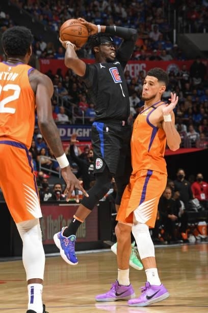 Devin Booker of the Phoenix Suns plays defense on Reggie Jackson of the LA Clippers during Game 6 of the Western Conference Finals of the 2021 NBA...