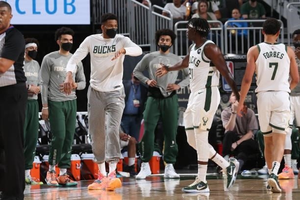 Giannis Antetokounmpo hi-fives Jrue Holiday of the Milwaukee Bucks during Game 5 of the Eastern Conference Finals of the 2021 NBA Playoffs on July 1,...