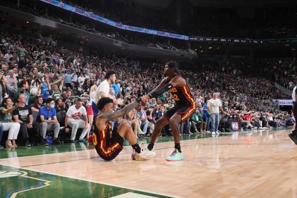 Cam Reddish helps up John Collins of the Atlanta Hawks during Game 5 of the Eastern Conference Finals of the 2021 NBA Playoffs on July 1, 2021 at the...