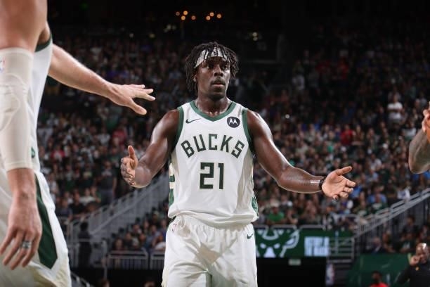 Jrue Holiday of the Milwaukee Bucks high fives a teammate during Game 5 of the Eastern Conference Finals of the 2021 NBA Playoffs on July 1, 2021 at...