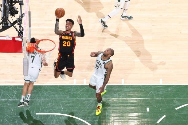 John Collins of the Atlanta Hawks drives to the basket against the Milwaukee Bucks during Game 5 of the Eastern Conference Finals of the 2021 NBA...
