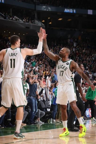 Brook Lopez and P.J. Tucker of the Milwaukee Bucks high five during Game 5 of the Eastern Conference Finals of the 2021 NBA Playoffs on July 1, 2021...