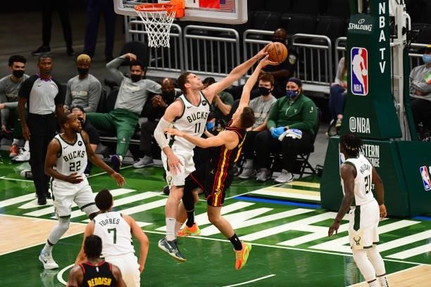 Brook Lopez of the Milwaukee Bucks blocks a shot by Bogdan Bogdanovic of the Atlanta Hawks during Game 5 of the Eastern Conference Finals of the 2021...