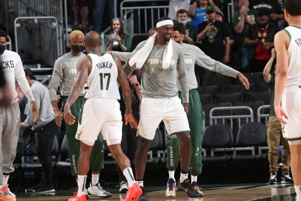Bobby Portis hi-fives P.J. Tucker of the Milwaukee Bucks during Game 5 of the Eastern Conference Finals of the 2021 NBA Playoffs on July 1, 2021 at...