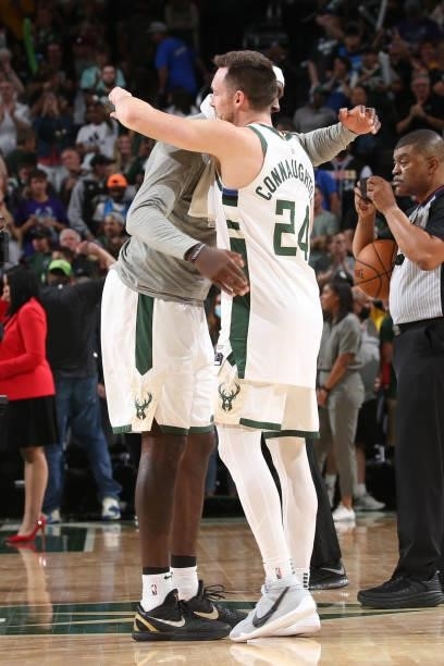 Bobby Portis hi-fives Pat Connaughton of the Milwaukee Bucks during Game 5 of the Eastern Conference Finals of the 2021 NBA Playoffs on July 1, 2021...