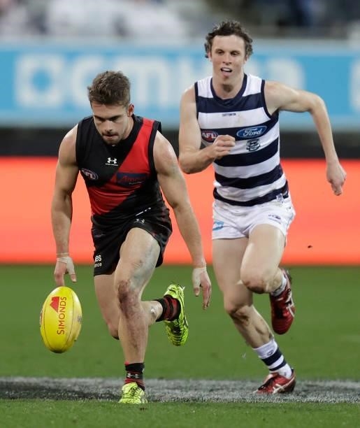 Will Snelling of the Bombers and Max Holmes of the Cats in action during the 2021 AFL Round 16 match between the Geelong Cats and the Essendon...