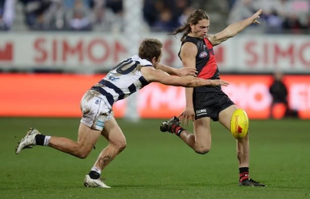 Archie Perkins of the Bombers and Tom Atkins of the Cats in action during the 2021 AFL Round 16 match between the Geelong Cats and the Essendon...