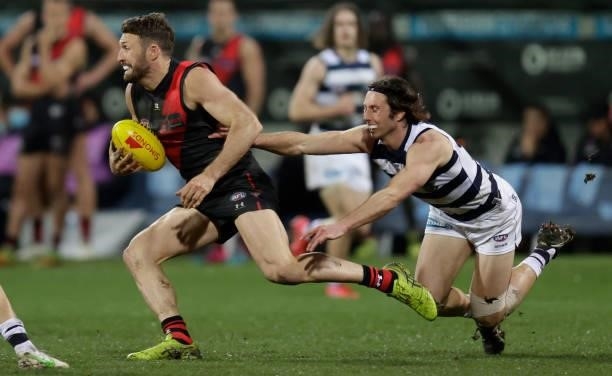 Cale Hooker of the Bombers and Jack Henry of the Cats in action during the 2021 AFL Round 16 match between the Geelong Cats and the Essendon Bombers...