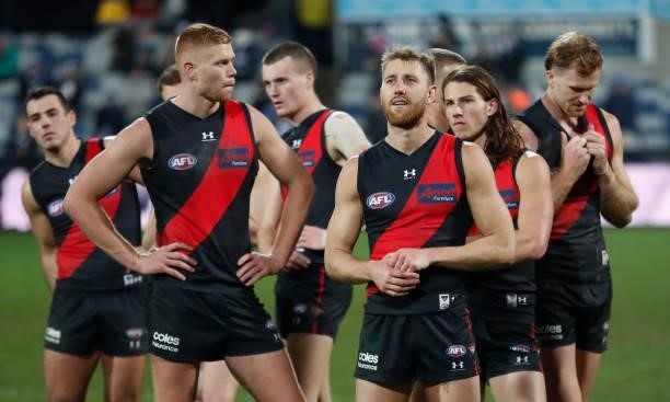 The Bombers look dejected after a loss during the 2021 AFL Round 16 match between the Geelong Cats and the Essendon Bombers at GMHBA Stadium on July...