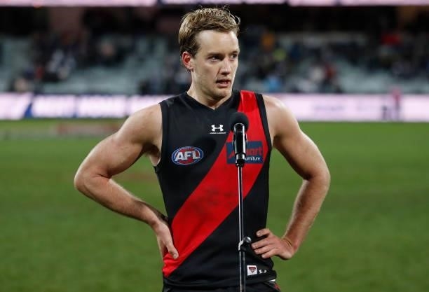 Darcy Parish of the Bombers speaks to the crowd after winning the Tom Wills Medal during the 2021 AFL Round 16 match between the Geelong Cats and the...