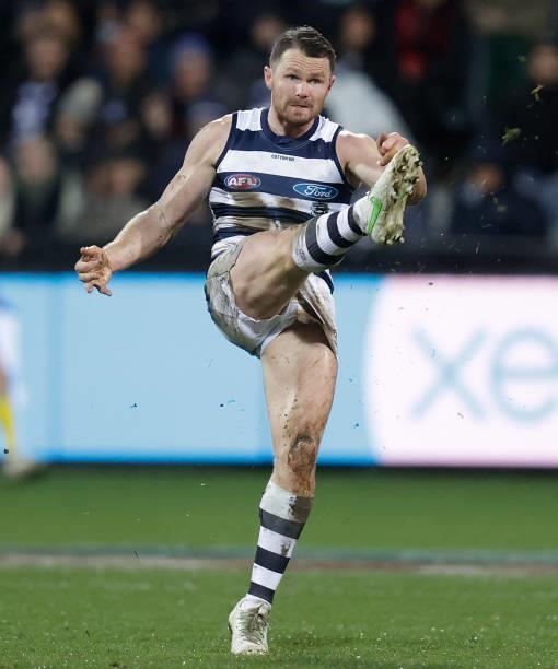 Patrick Dangerfield of the Cats kicks the ball during the 2021 AFL Round 16 match between the Geelong Cats and the Essendon Bombers at GMHBA Stadium...