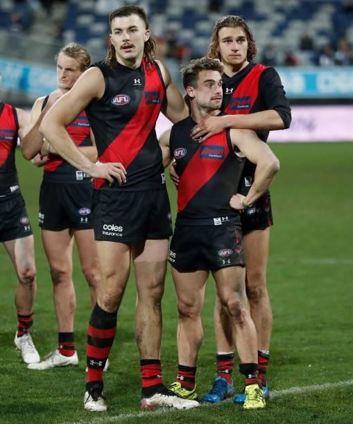 Sam Draper, Will Snelling and Harrison Jones of the Bombers look dejected after a loss during the 2021 AFL Round 16 match between the Geelong Cats...