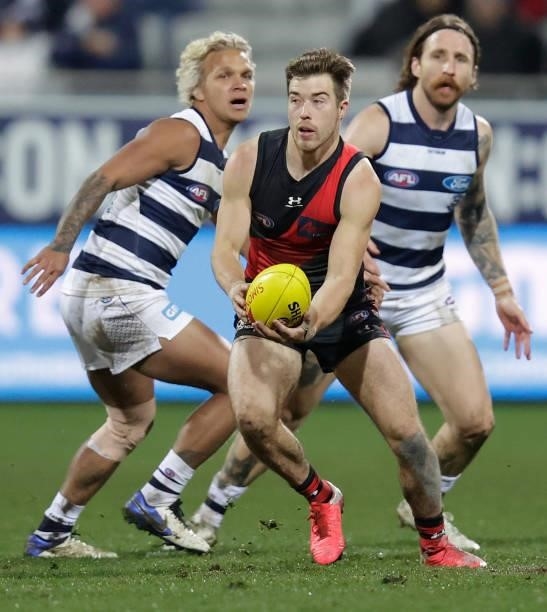 Zach Merrett of the Bombers in action during the 2021 AFL Round 16 match between the Geelong Cats and the Essendon Bombers at GMHBA Stadium on July...
