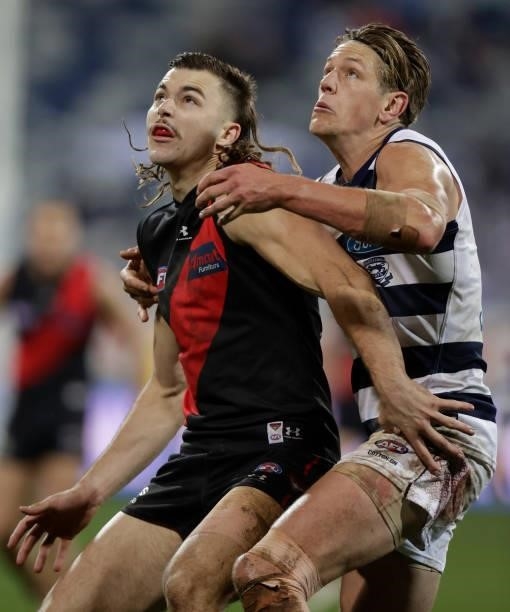 Sam Draper of the Bombers and Rhys Stanley of the Cats compete in a ruck contest during the 2021 AFL Round 16 match between the Geelong Cats and the...