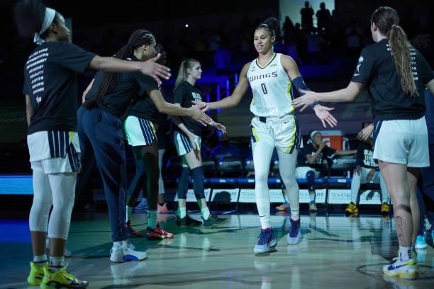 Satou Sabally of the Dallas Wings high fives her teammates before the game against the Chicago Sky on July 2, 2021 at the College Park Center in...