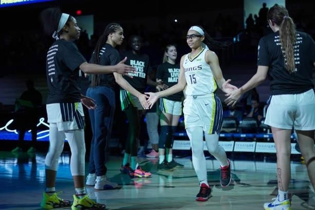 Allisha Gray of the Dallas Wings high fives her teammates before the game against the Chicago Sky on July 2, 2021 at the College Park Center in...