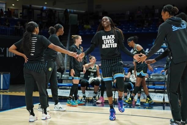 Kahleah Cooper of the Chicago Sky high fives her teammates before the game against the Dallas Wings on July 2, 2021 at the College Park Center in...