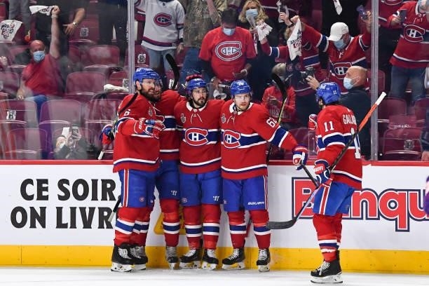 Phillip Danault of the Montreal Canadiens celebrates with teammates after scoring a goal against the Tampa Bay Lightning in Game Three of the Stanley...