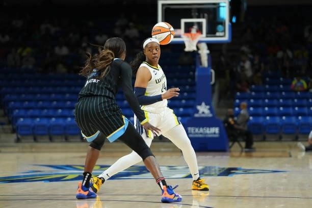 Arike Ogunbowale of the Dallas Wings handles the ball against Kahleah Cooper of the Chicago Sky on July 2, 2021 at the College Park Center in...