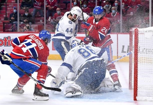 Goalie Andrei Vasilevskiy and Jan Rutta of the Tampa Bay Lightning defend the net against Phillip Danault and Brendan Gallagher of the Montreal...