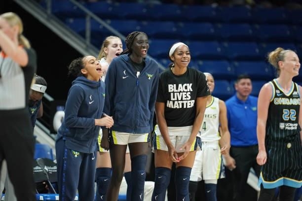 Chelsea Dungee of the Dallas Wings and teammates Awak Kuier and Charli Collier celebrate during the game against the Chicago Sky on July 2, 2021 at...