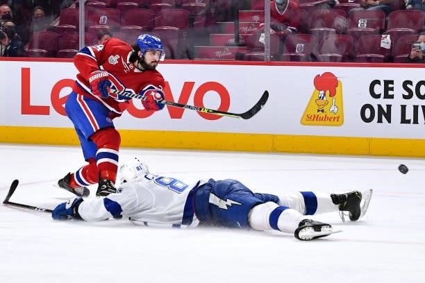 Erik Cernak of the Tampa Bay Lightning slides trying to block a shot by Phillip Danault of the Montreal Canadiens in Game Three of the Stanley Cup...