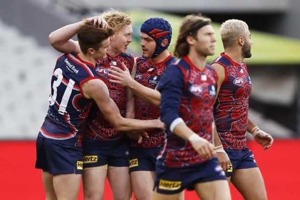 Bayley Fritsch of the Demons celebrates a goal with Clayton Oliver and Angus Brayshaw during the 2021 AFL Round 16 match between the Melbourne Demons...