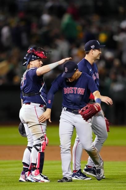 Christian Vázquez of the Boston Red Sox celebrates with Enrique Hernández and with Adam Ottavino after the game between the Boston Red Sox and the...