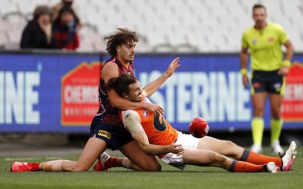 Luke Jackson of the Demons and Phil Davis of the Giants compete for the ball during the 2021 AFL Round 16 match between the Melbourne Demons and the...