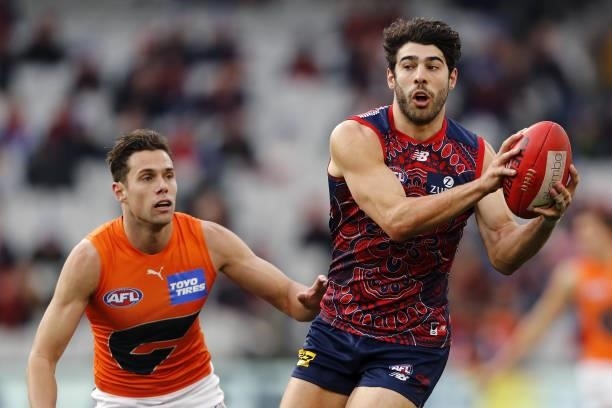 Christian Petracca of the Demons marks the ball against Josh Kelly of the Giants during the 2021 AFL Round 16 match between the Melbourne Demons and...