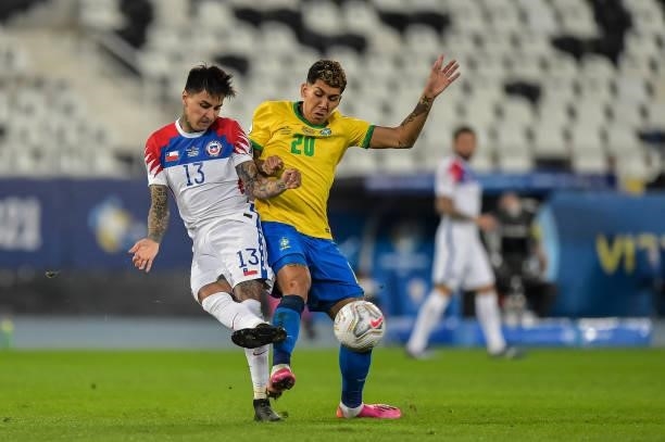 Roberto Firmino player from Brazil disputes a bid with Pulgar player from Chile during a match at the Engenhão stadium for the Copa América 2021, on...