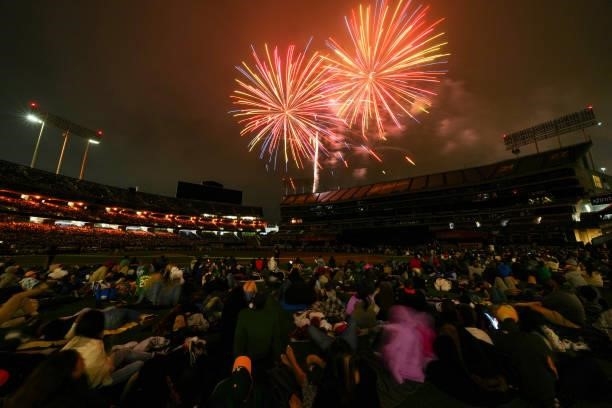 Fans look on during a patriotic fireworks show after the game between the Boston Red Sox and the Oakland Athletics at Oakland Coliseum on Friday,...