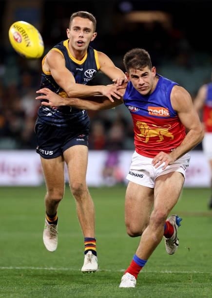 Lachlan Sholl of the Crows competes with Jack Payne of the Lions during the 2021 AFL Round 16 match between the Adelaide Crows and the Brisbane Lions...
