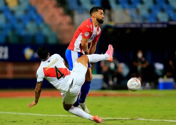 Alberto Espinola of Paraguay competes for the ball against Anderson Santamaria of Peru during the Quarterfinal match between Peru and Paraguay as...